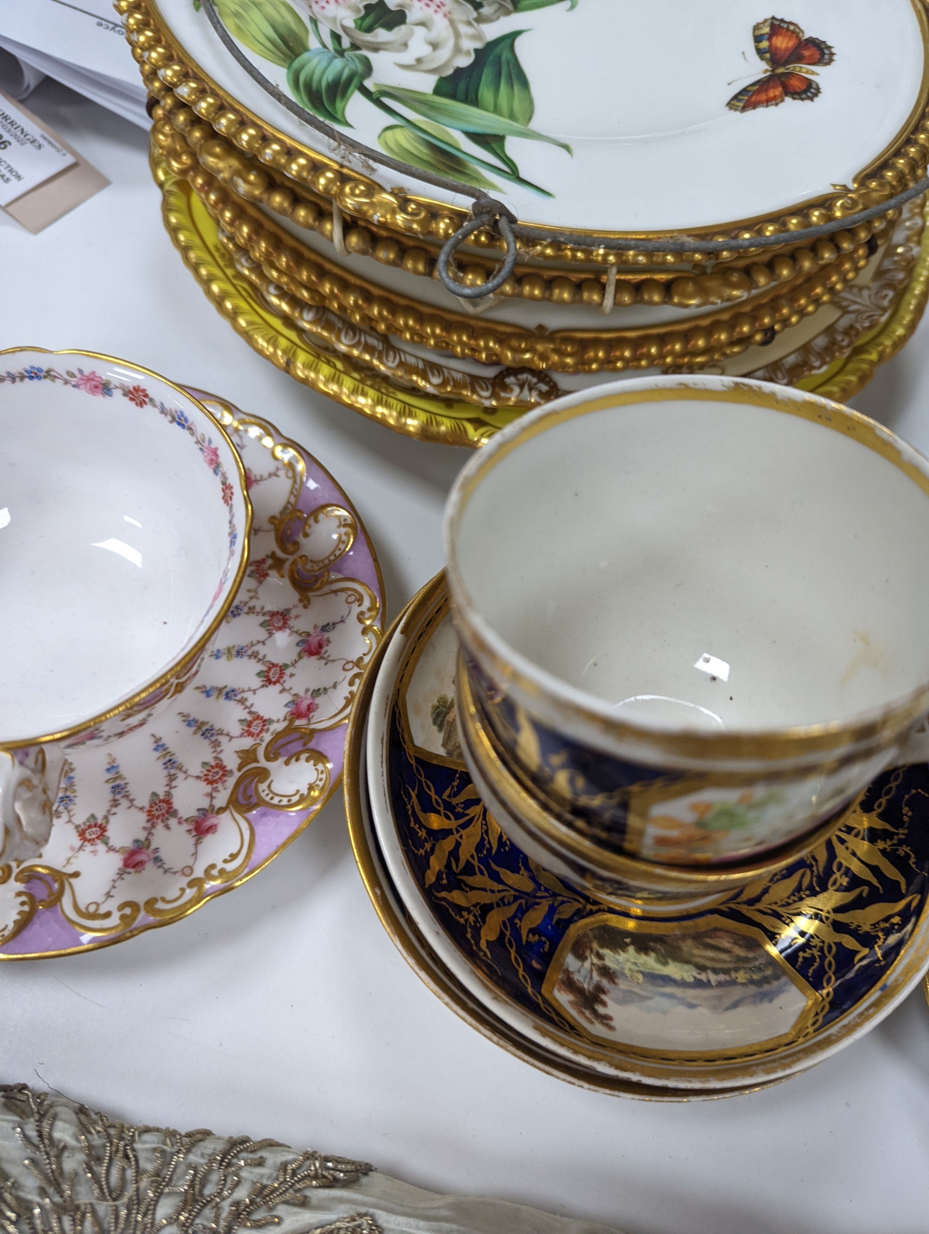 A small collection of Victorian porcelain tea cups and saucers and sundry dessert plates